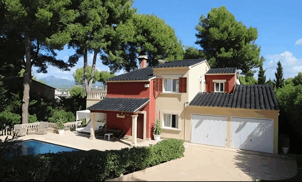 Image of a house with a black tiled roof