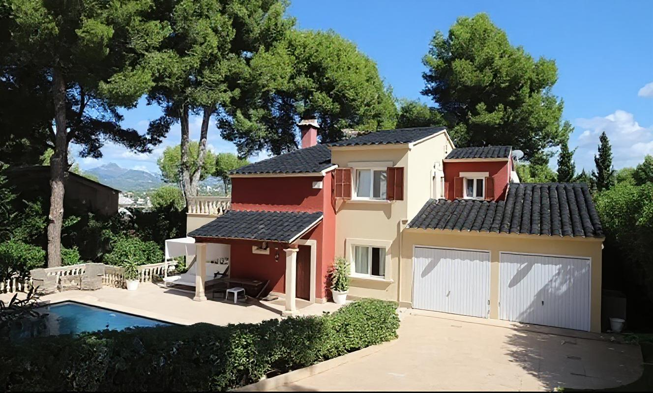 Image of a house with a black tiled roof